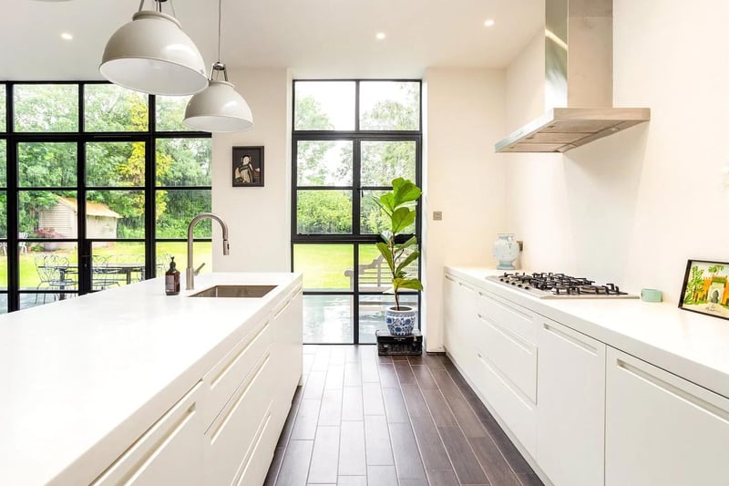 The kitchen is particularly impressive with bespoke units and corian worktops.