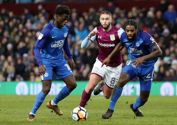 Leonardo Da Silva Lopes and Anthony Grant in action with Henri Lansbury of Aston Villa- Joe Dent/JMP.