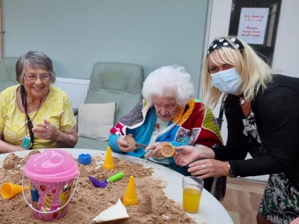 Manager Hayley Peace enjoying a day at the seaside with Audrey Jenney and Pat Blundell.