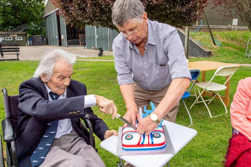 After Fred's tour of the East Coast Aviation Heritage Centre he cut his 100th birthday cake, helped by his son Geoff.