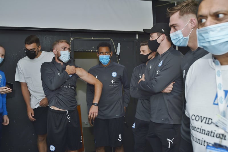 New vaccination centre opens at the Posh Ground.  Posh players waiting for their jabs EMN-210627-085627009