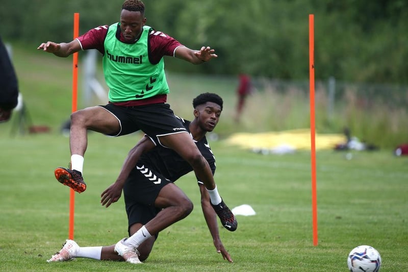 Nicke Kabamba, who was the first player to join Northampton this summer, holds off youth team player Peter Abimbola.