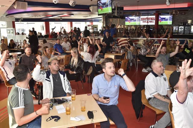 England fans at the Coyotes Bar, New Road, Peterborough EMN-210629-193410009