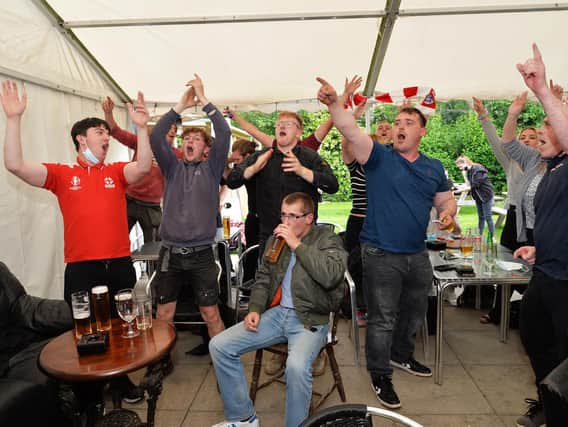 Fans celebrate England's victory against Germany at the Royalist in Market Harborough.