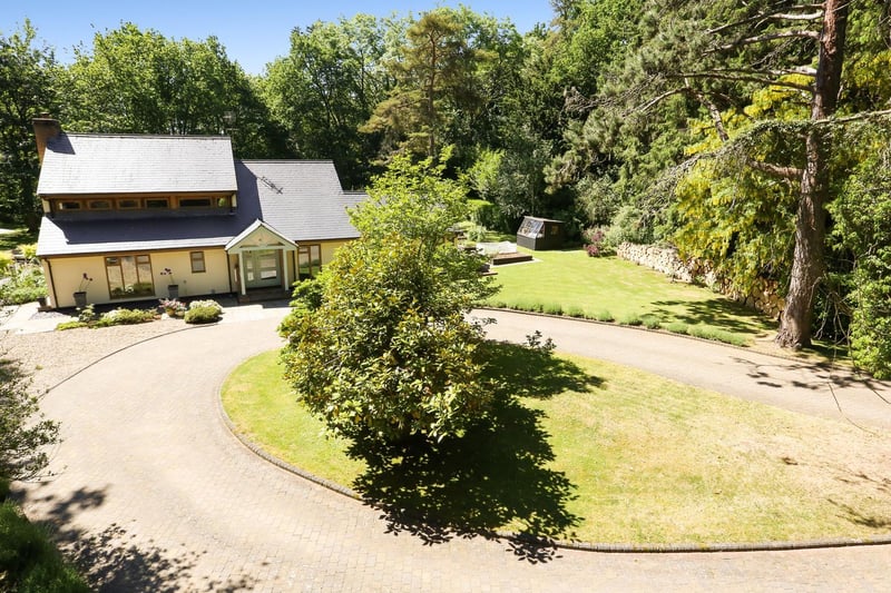 'A carriage driveway leads from the private lane via a five bar gate up to the house and timber barn with parking for three cars and extensive log storage'. Photo: Savills.