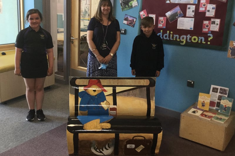 Charlotte and Bailey from St Michael's Church School alongside Sally Cartwright and their completed bench 'Paddington Comes to Peterborough’