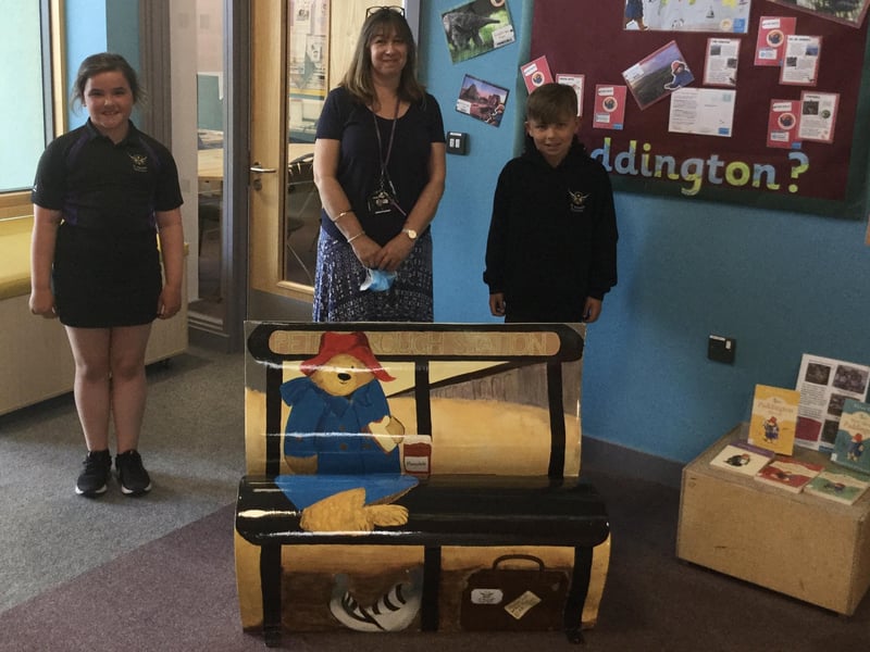 Charlotte and Bailey from St Michael's Church School alongside Sally Cartwright and their completed bench 'Paddington Comes to Peterborough’