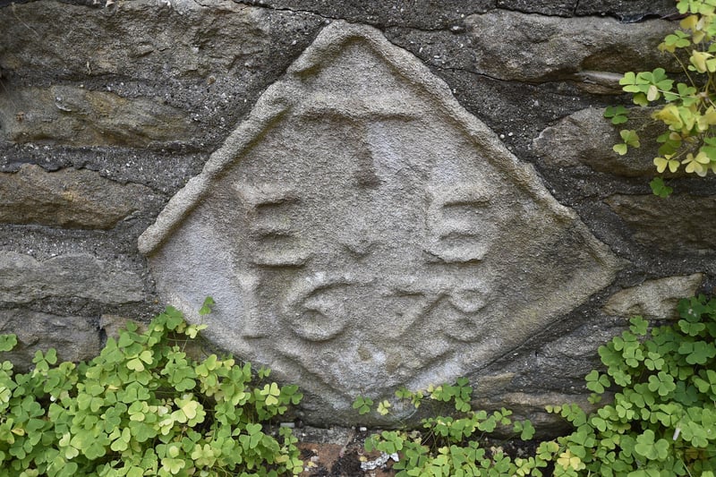 Stonework with the date 1678 in the rear garden of JW D'arcy. EMN-210630-161904009