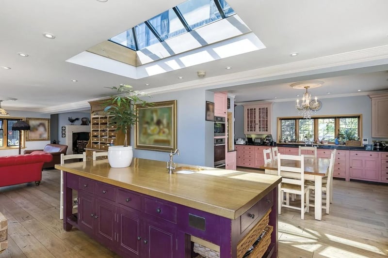 The kitchen/breakfast room has been hand built by Chalon, with custom made six-oven Aga, Miele appliances and beautiful oak flooring, flowing through into a substantial dining room.