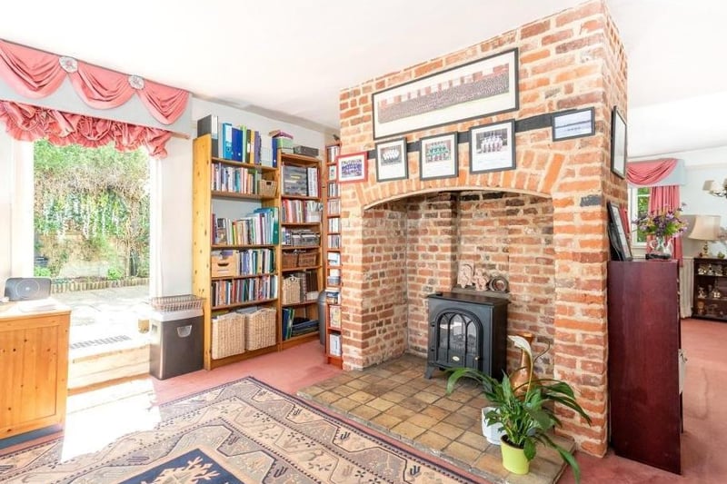Traditional brick hearth lies at the heart of this sitting room