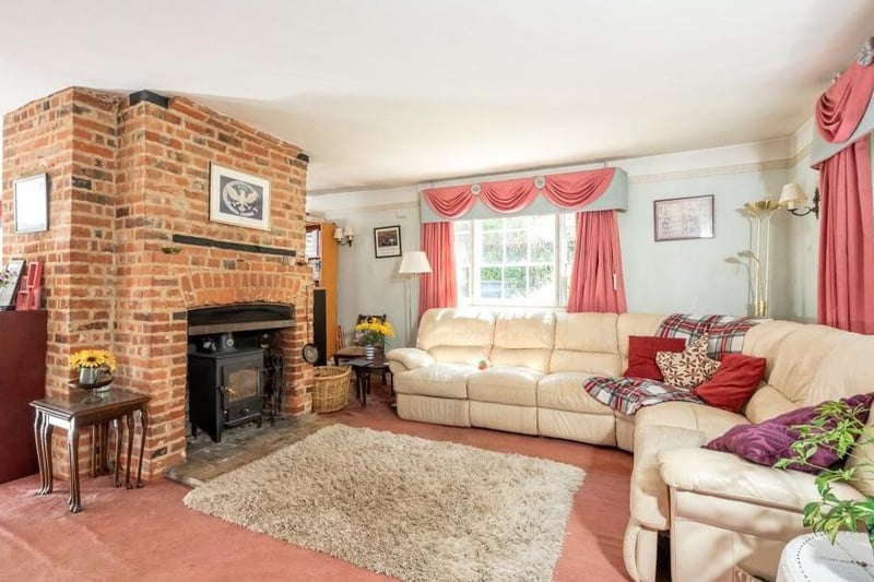 An impressive brick fireplace is the focal point of this cosy sitting room