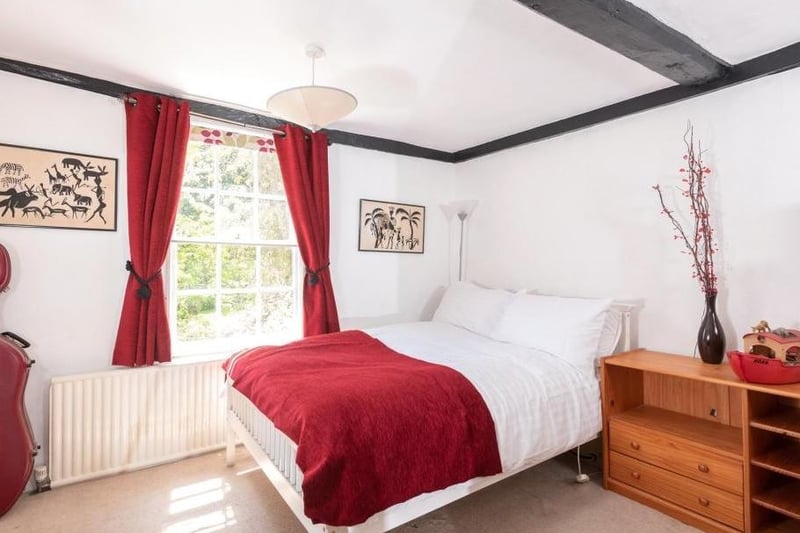 A fourth bedroom is equally atmospheric with wooden beams