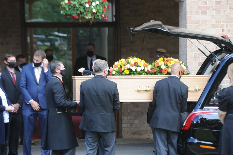 The coffin of Bernard Moore is carried into the crematorium.