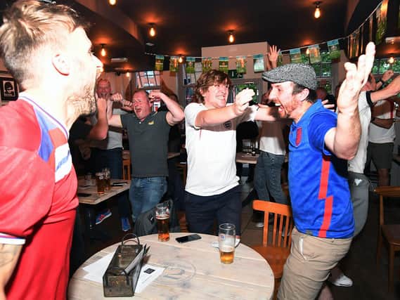 Joy as England fans celebrate drawing level with Denmark at Bar Fifty Three on The Square.