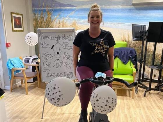 Emma Camm peddling for the therapy dog appeal.