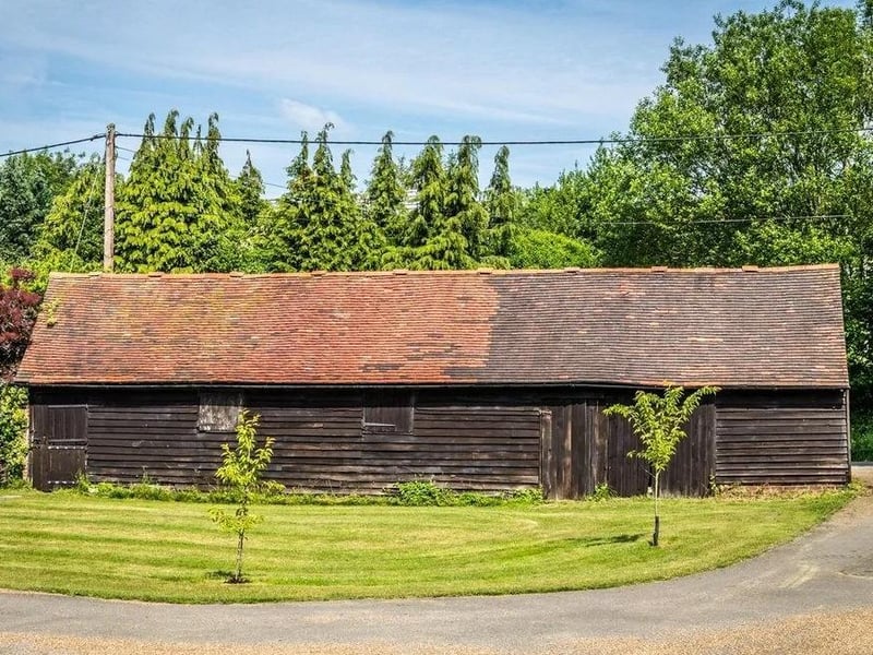 Opposite the garage is a large timber outbuilding, which was formerly a stable.