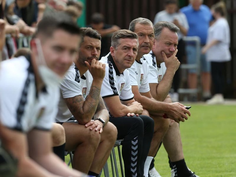 Cobblers' recently-appointed coaching team watch on, minus new goalkeeping coach James Alger who is currently isolating.