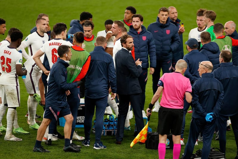 Gareth Southgate, Head Coach of England (C) looks on as he speaks with his players before extra-time
