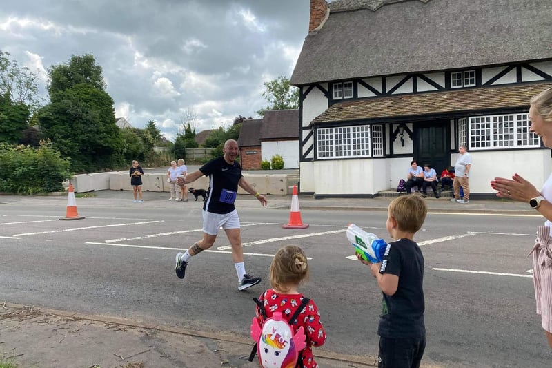 Ethan and Sienna Rawlings cooling the runners down in Radford Semele during the Leamington Half Marathon yesterday. Photo by Si Rawlings.