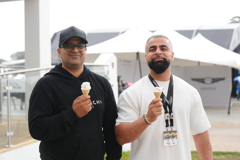 Goodwood Festival of Speed in Chichester on Saturday, July 10, 2021.

Pictured is: (l-r) Kam Mirza and Shaf Rehman who came all the way from Birmingham to enjoy the event and what better way with an ice cream in the rain.

Picture: Sarah Standing (100721-7504) PPP-211107-103148003