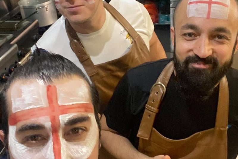 Mesut and the kitchen team at Tablez, Sleaford, all painted up ahead of the England match. EMN-211207-120029001