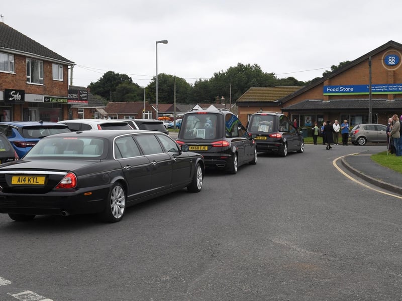 Members of the community stood on the Green to watch the funeral cortege pass by.