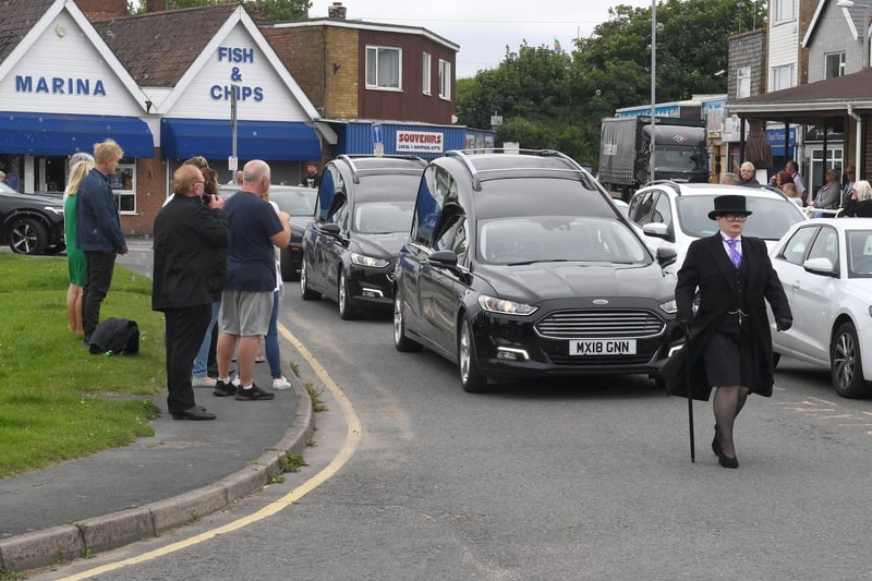 The funeral cortege turns towards the main road to continue its journey to Alford Crematorium.