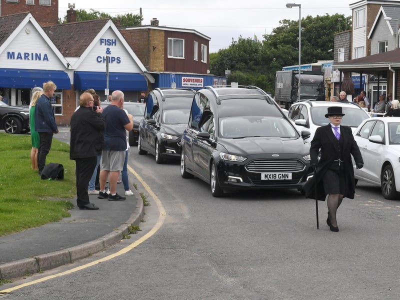 The funeral cortege turns towards the main road to continue its journey to Alford Crematorium.