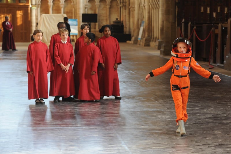 Bobbi Crooks (7) in her spacesuit with Cathedral Choristers.