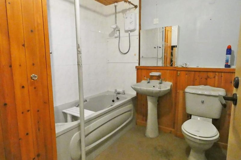 The fitted family bathroom has a shower over the bath.