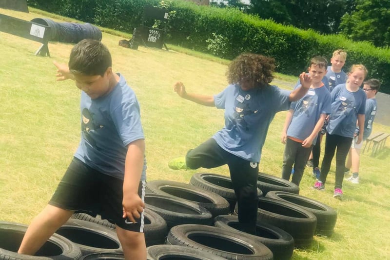 Children tackle the tyre runs