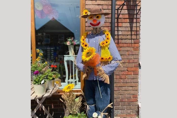 The Florist displayed a scarecrow in the shop window