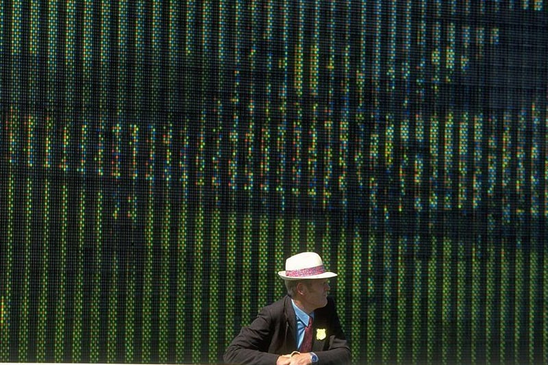 1992 and a racegoer leans over a rail in front of a giant video screen during the  festival / Picture: Allsports UK /Allsport