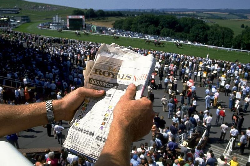 A racegoer studies the form during Glorious Goodwood week in 1992 \  Allsport UK /Allsport
