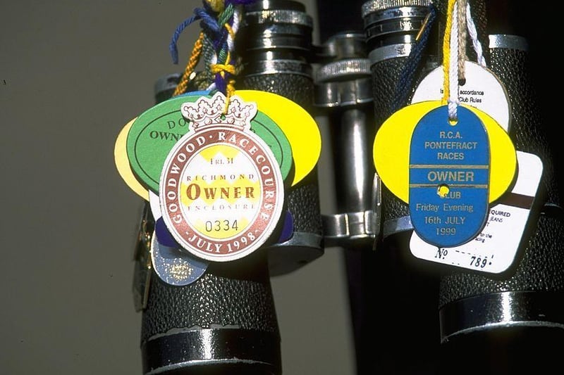 Owner's badges adorn a pair of binoculars at the festival in the late 1990s / Picture: Phil Cole / Allsport
