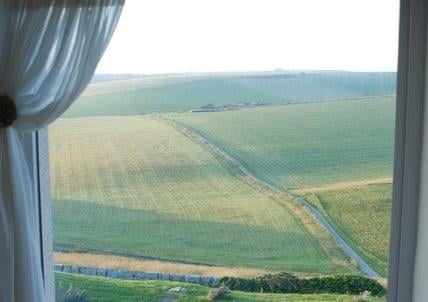 View over the fields from Belle Tout lighthouse, Beachy Head, Eeastbourne, by Bob Newton. SUS-210726-114050001