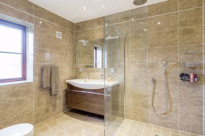 A large shower in one of the six bathrooms