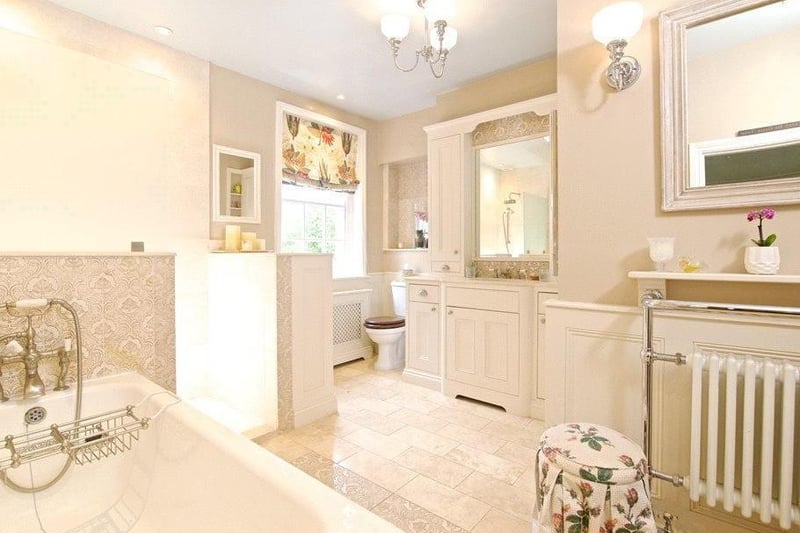 an all-white, rococo style bathroom oozes luxury