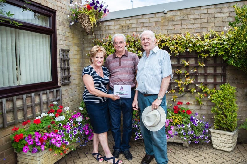 Teresa and Michael Hodges (left and middle) picked up the runner-up prize for the front garden category and were presented with a certificate by Richard Dron (right).
Teresa said: “I’m really pleased.
“Gardening is everything to me, I do it all the time and I’m often out here until 10pm.
“It’s my favourite hobby.”
Photo: Kirsty Edmonds.