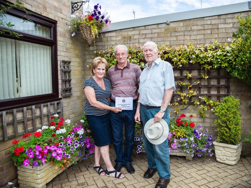 Teresa and Michael Hodges (left and middle) picked up the runner-up prize for the front garden category and were presented with a certificate by Richard Dron (right).
Teresa said: “I’m really pleased.
“Gardening is everything to me, I do it all the time and I’m often out here until 10pm.
“It’s my favourite hobby.”
Photo: Kirsty Edmonds.