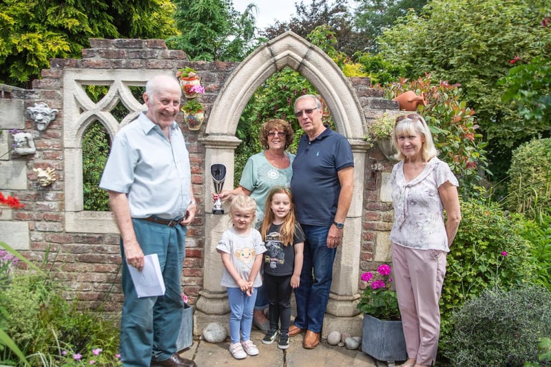 Last year’s back garden winner, Frances Boddington (right), her granddaughter Isla (middle left) and Richard Dron (left) presented the award to this year’s winners: Gill and Malcolm Salmon and their granddaughter Poppy Field (middle right). 
Photo: Kirsty Edmonds.