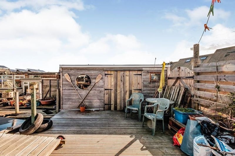 Spacious decking area, perfect for sunsent views, with a sizeable wooden shed for storage