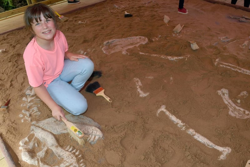 Lily Hart of Orby discovering dinosaur bones in The Dig.