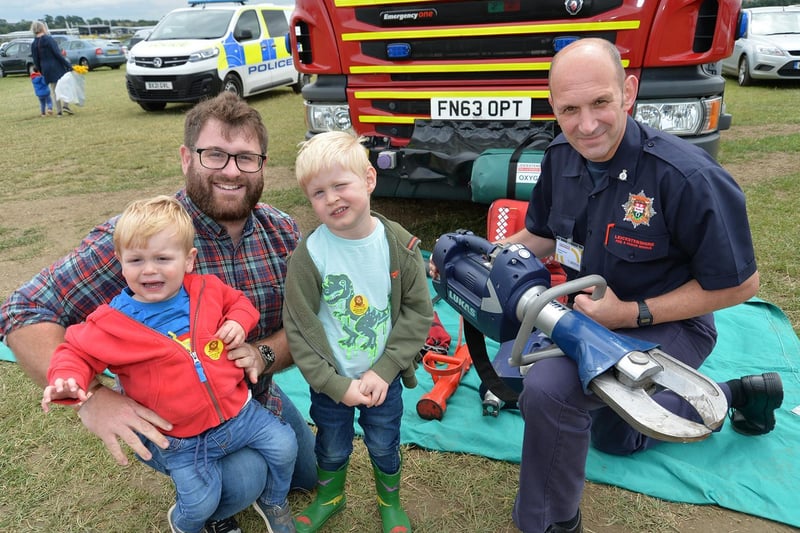Firefighter Andrew Marriott with Hugo, 20 months, Colbert, 4, and Chris Brown during the Summer Fayre at the Market Harborough Showground.