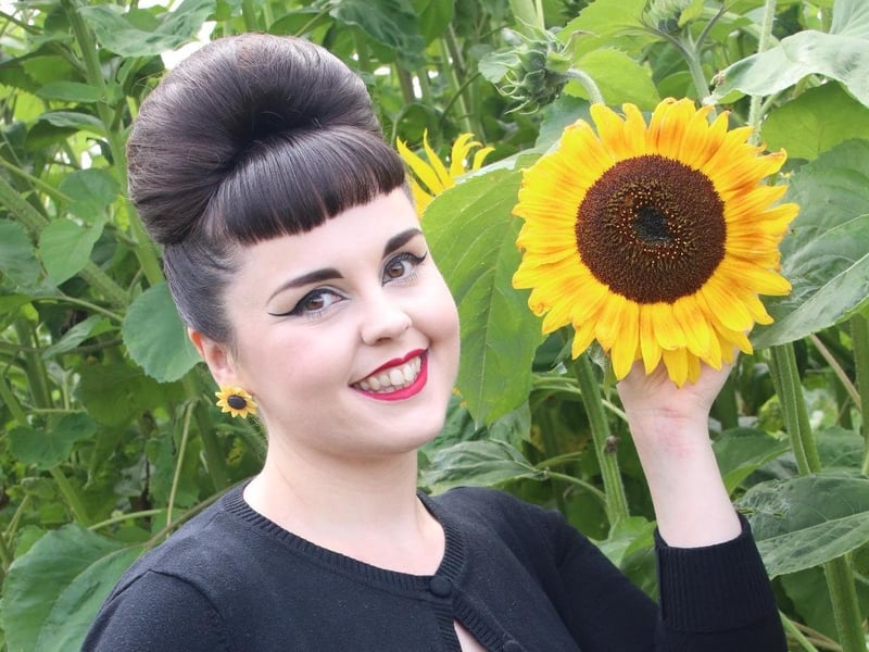 Rachel Greenyer with a sunflower SUS-210408-101947001