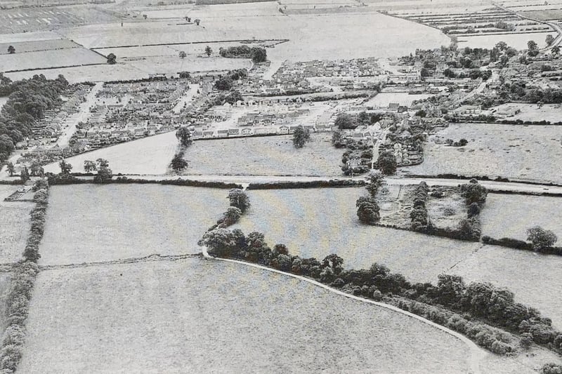 This picture was taken in 1971 and shows Orton Waterviille surrounded by farmland. Large parts of the open land seen here were built on to create the Orton townships. The land at the front of the picture is now part of 
Orton golf course.