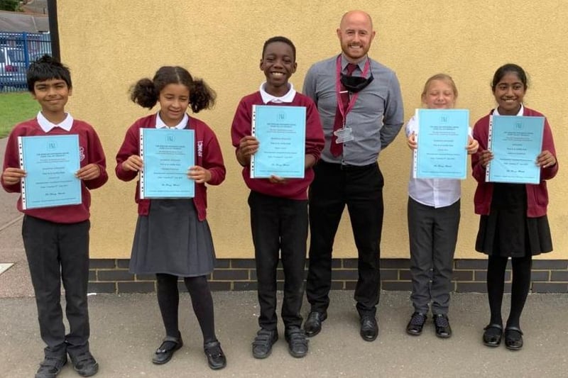 Speaker Lakshmi and reserves, Isaiah, Emily, Georgia and Elijah receiving their participation certificates with teacher Mr Redley