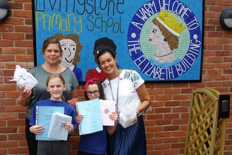 Speaker Rosie and reserve Emma receiving their participation certificates with teaching staff Mrs Dyas and Mrs Lara