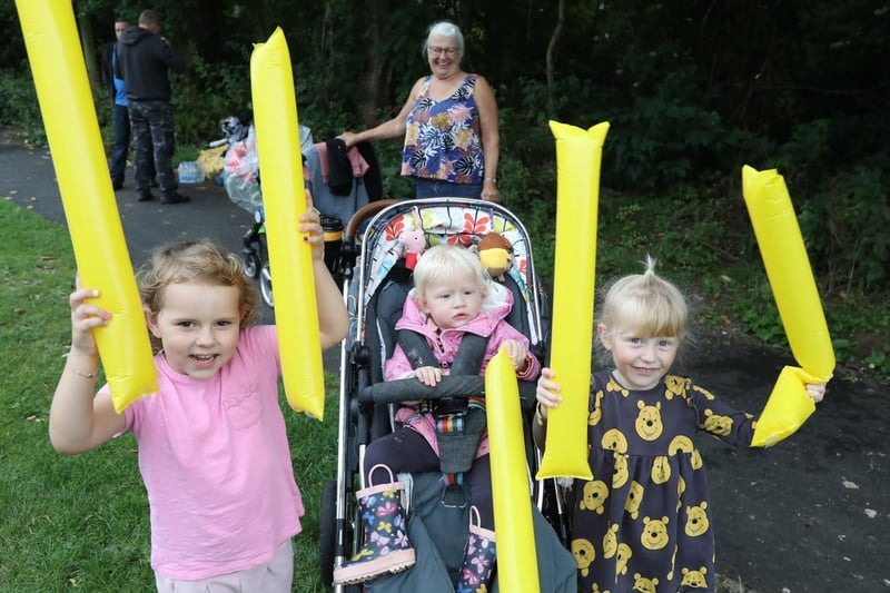 Cousins Bonnie Smith, 4, Freya Welch, 1, and Thea Welch, 3, cheer on their mums