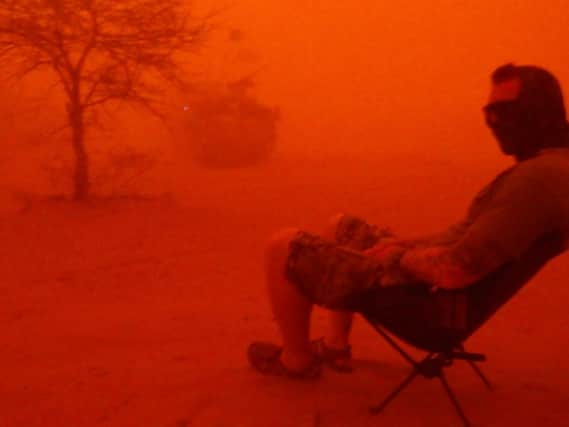 A soldier sat in a sandstorm